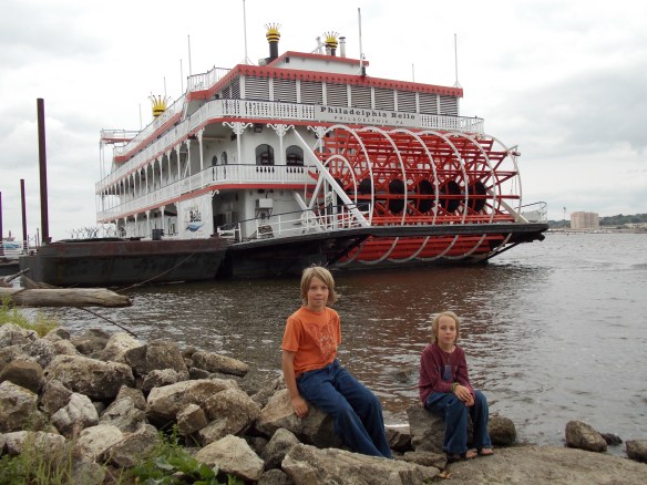 Logan & Cole in front of paddle wheel boat in Moline, IL.