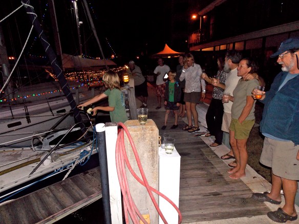 Logan spraying champagne on the bow at the end of the renaming ceremony.