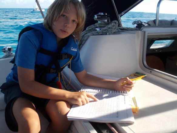 Logan doing school work on Truansea on the way to Black Point on Great Guana Cay.