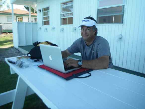 Mark at picnic table behind laundromat catching up on emails.