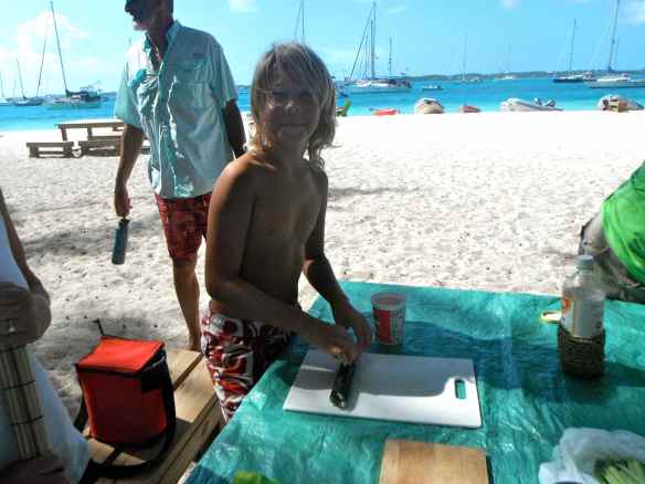 Logan learning to make sushi on the beach.