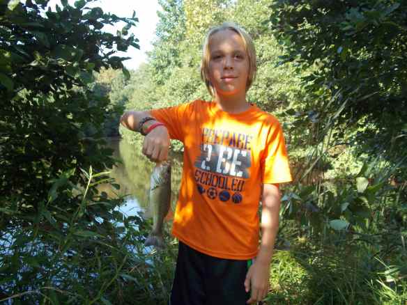 Cole with a bass he caught.