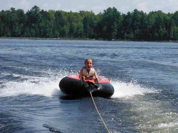 Cole having fun being pulled on the tube.